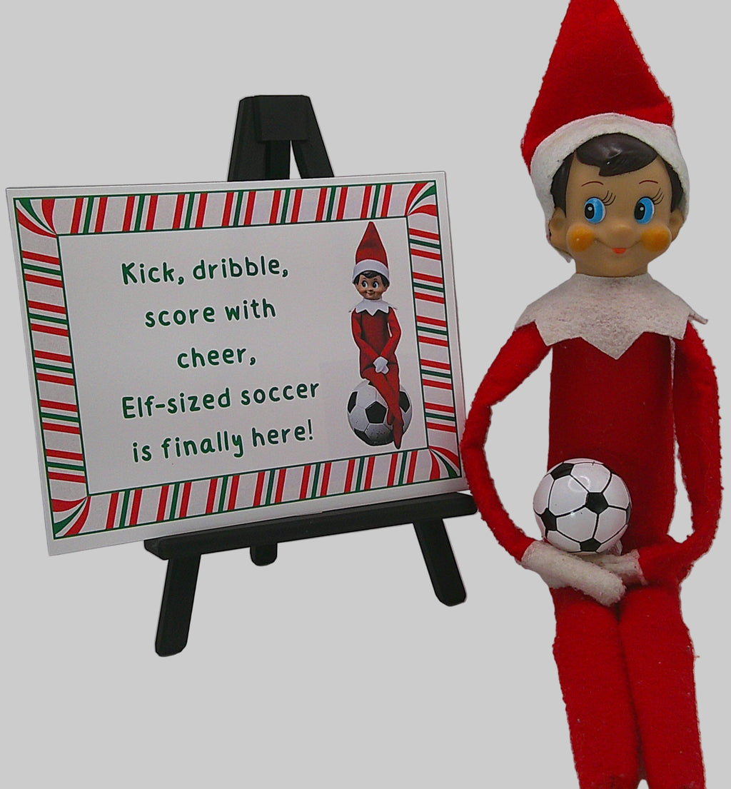 Elf on the Shelf holding a soccer ball next to a sign about Elf-sized soccer