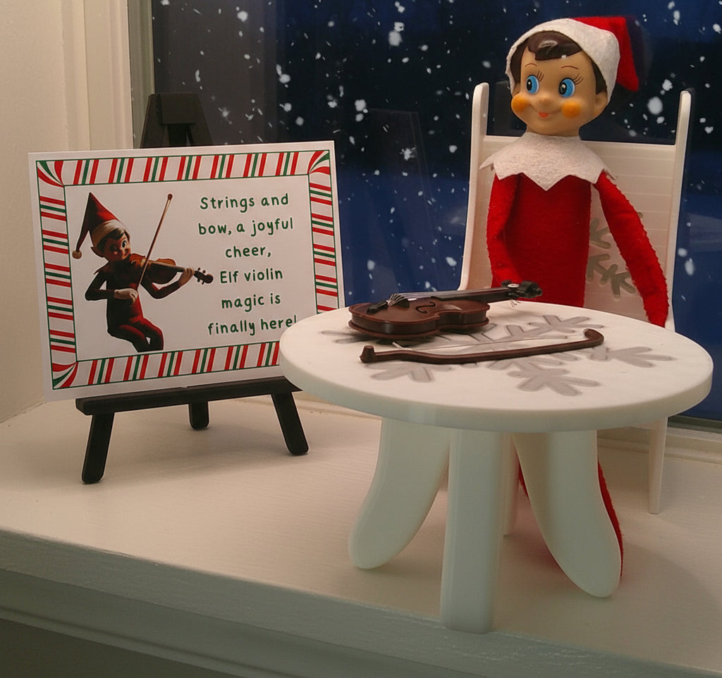 Elf on the Shelf with violin and sign on a white surface