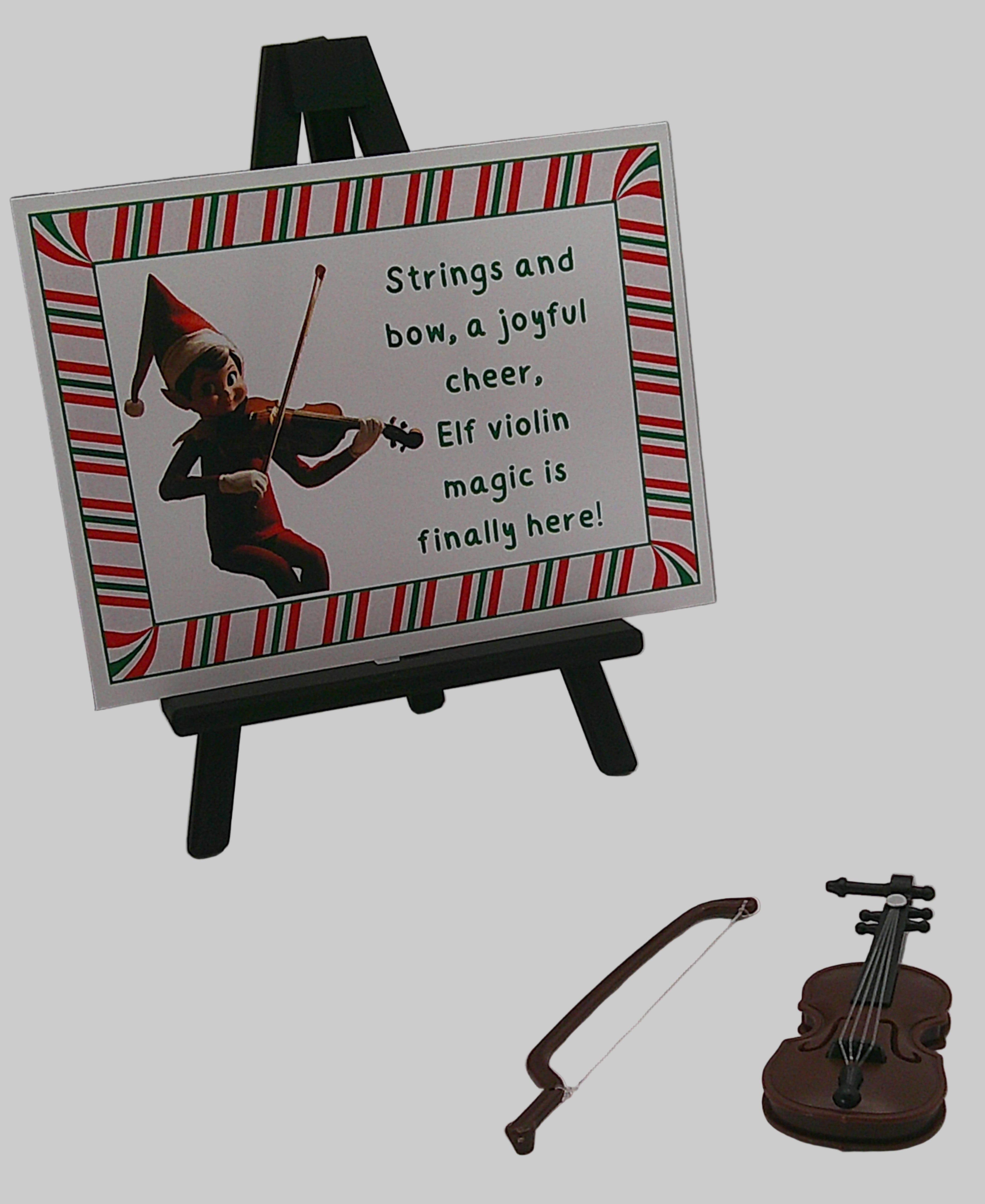 Small violin with bow and a card featuring an elf playing violin on a white background