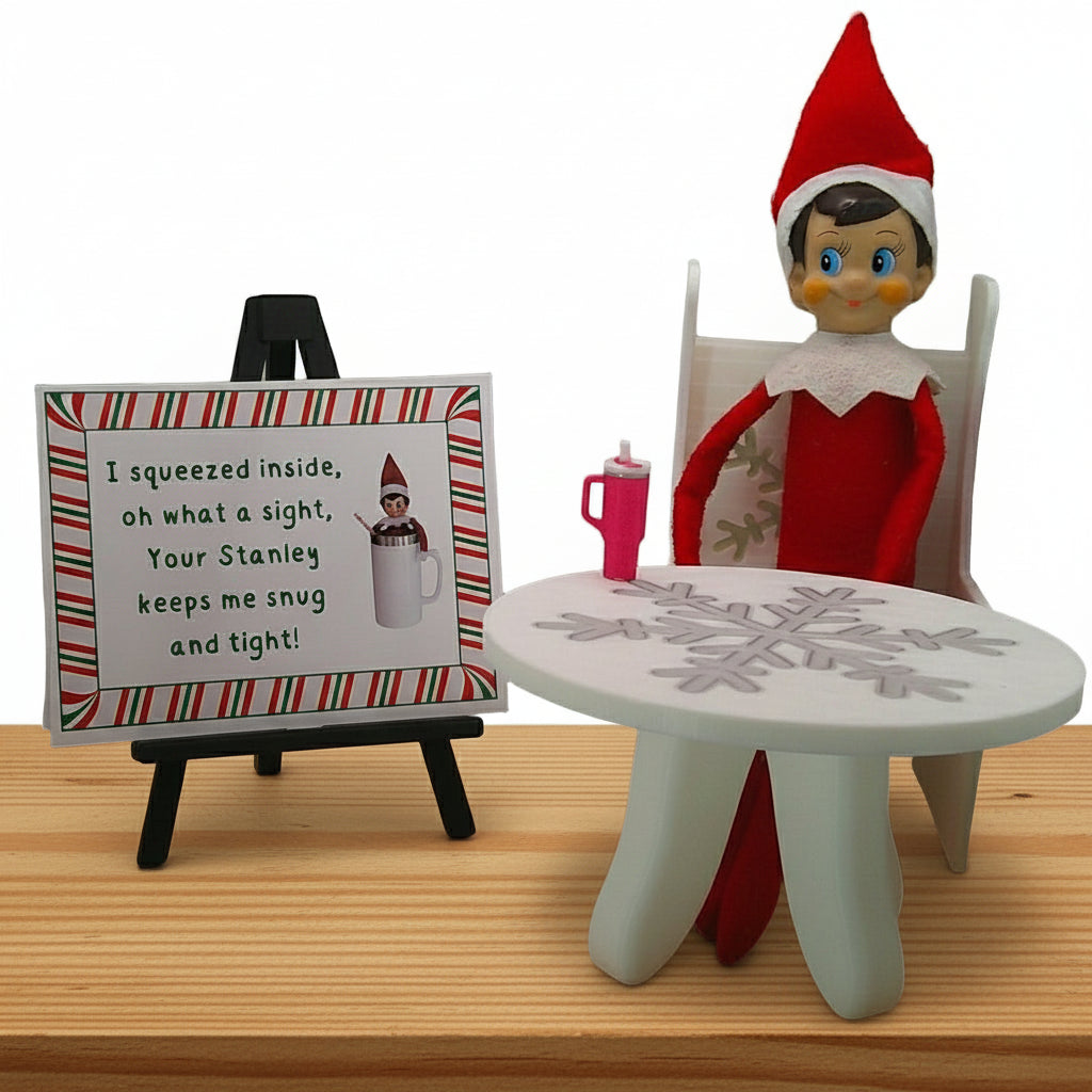 Elf on the Shelf with a sign and small table in a room setting